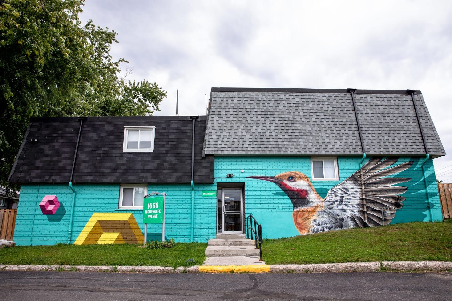Woodroffe Towns: mural of a northern flicker on the end wall of 1668 Woodroffe Avenue, furnished townhouses in Nepean, Ottawa
