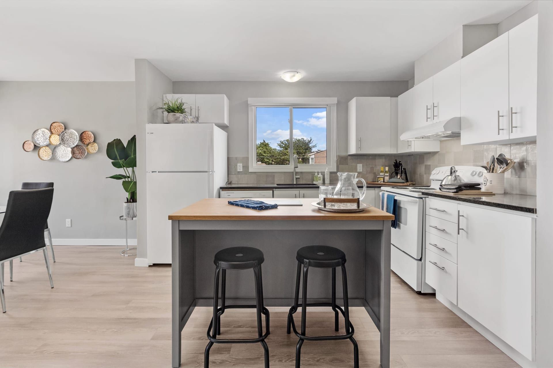 Woodroffe Towns: kitchen with a butcher-block island and stools, furnished townhouse in Nepean, Ottawa